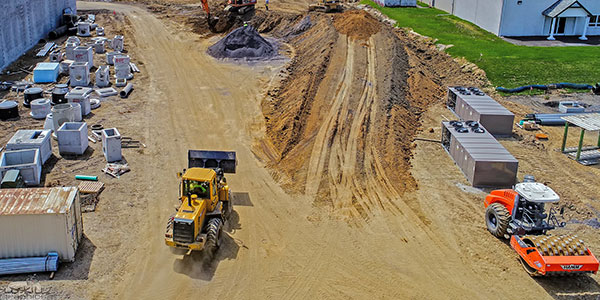 Photo of large digging equipment moving large amounts of soil