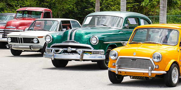 Photo of a lineup of multi-color vintage cars
